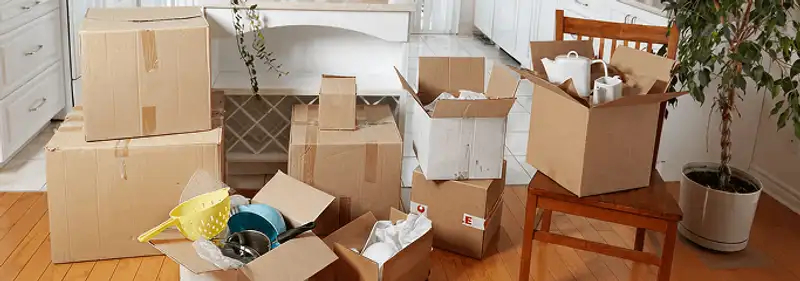 Packed moving boxes and household items in a kitchen before move-out or move-in cleaning, Fort Collins, CO.
